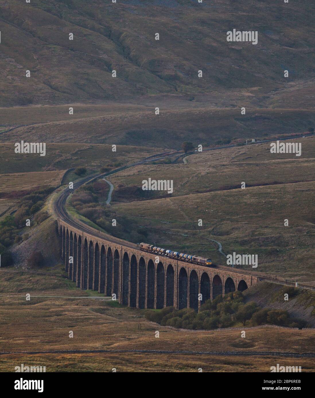 2 Direct Rail services class 66 locomotives pass Ribblehead viaduct with a network rail railhead treatment train clearing autumn  leaves from the line Stock Photo