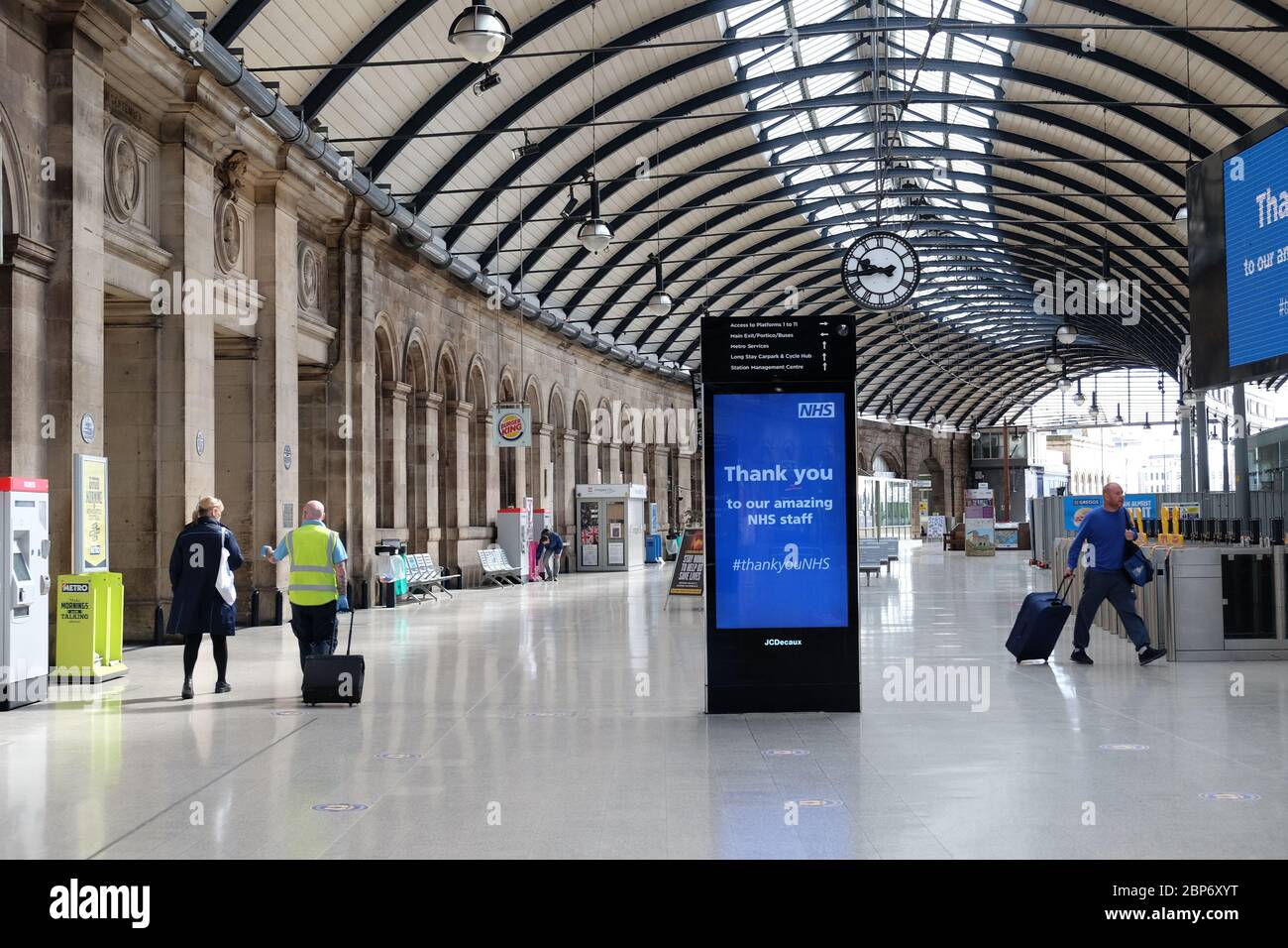 Passengers and rail staff at Newcastle train station, as train services increase as part of the easing of coronavirus lockdown restrictions. Stock Photo