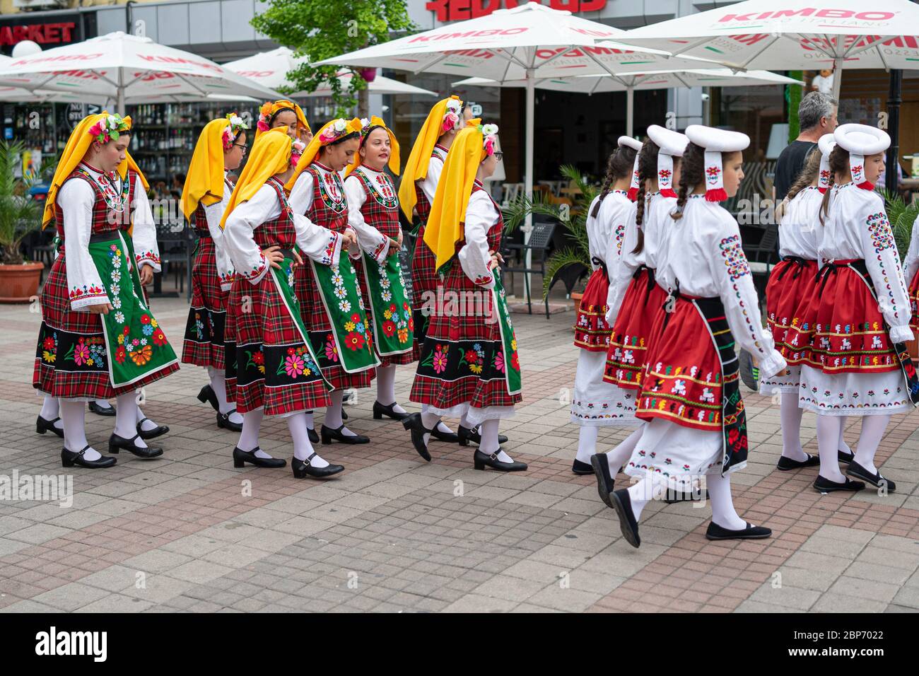 POMORIE, BULGARIA - JUNE 21, 2019: A group of children in Bulgarian national costumes on the streets. Stock Photo