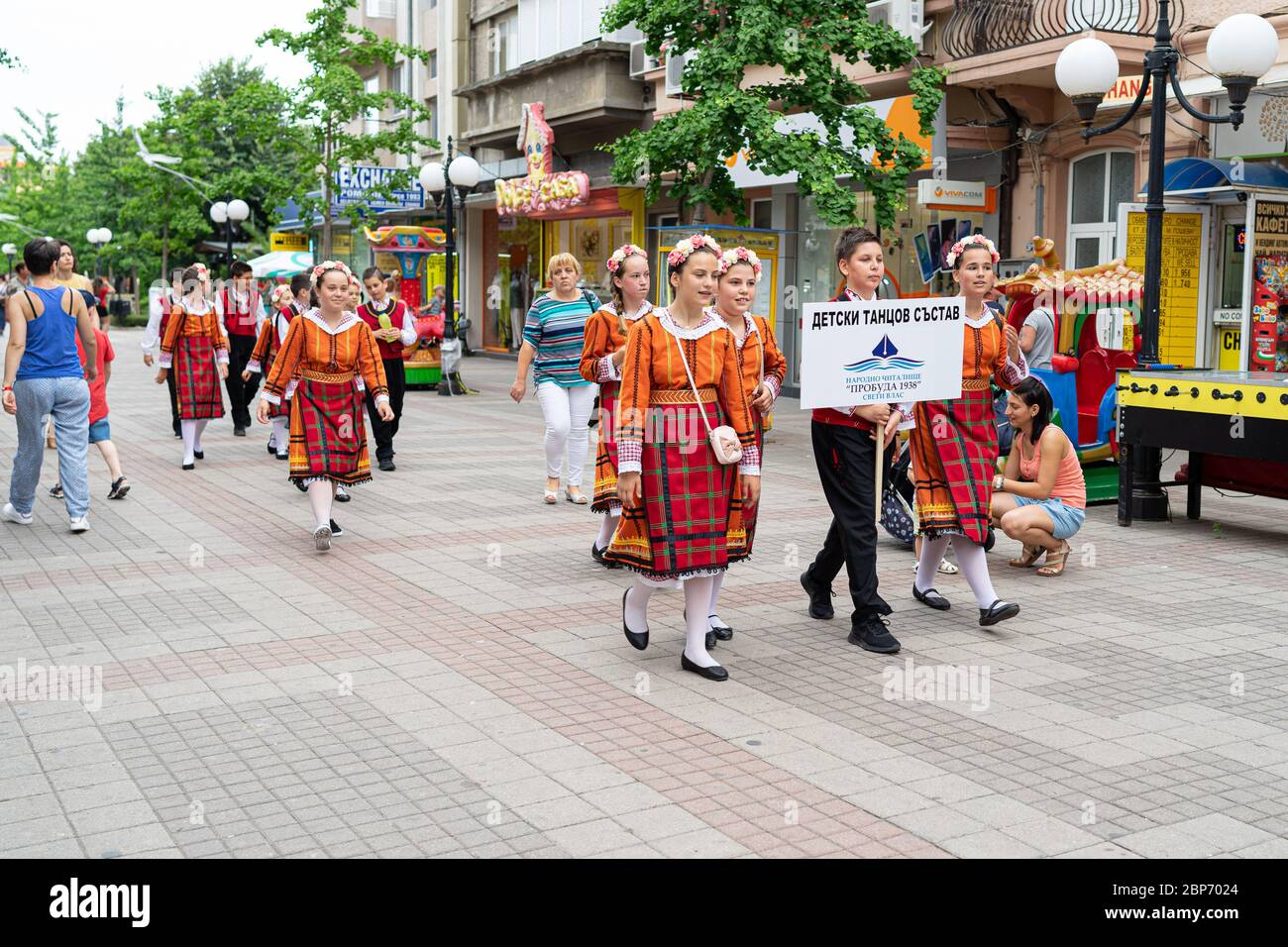 POMORIE, BULGARIA - JUNE 21, 2019: A group of children in Bulgarian national costumes on the streets. Stock Photo
