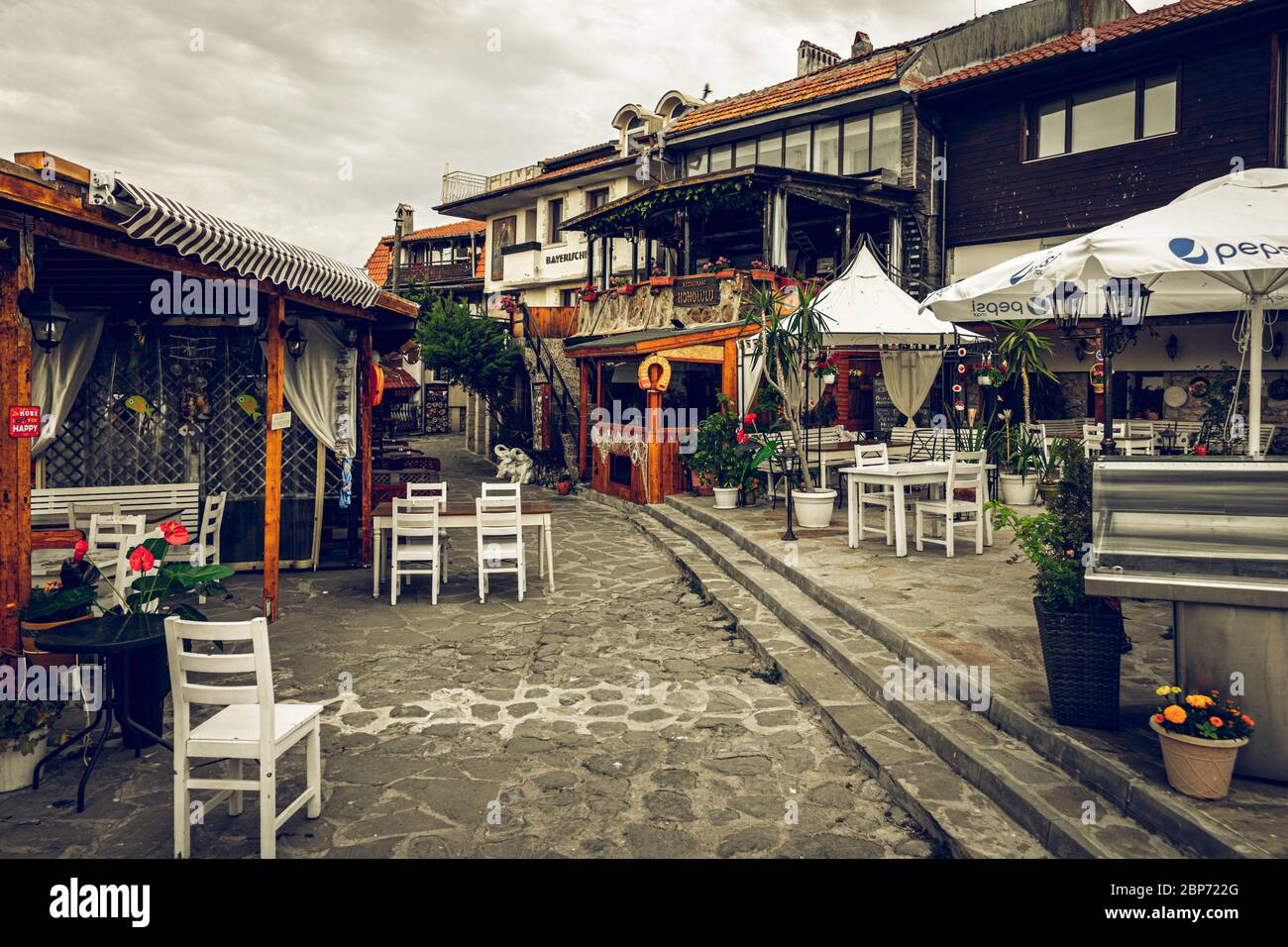 NESSEBAR, BULGARIA - JUNE 22, 2019: Closed restaurant on the promenade of the ancient coastal city. Early morning. Toning, Stylization. Stock Photo