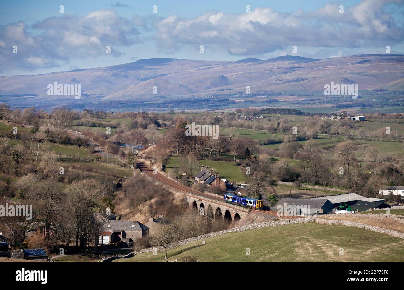 Northern Rail class 158 train in the landscape passing the countryside passing Crosby Garrett viaduct on the scenic Settle to Carlisle railway Stock Photo