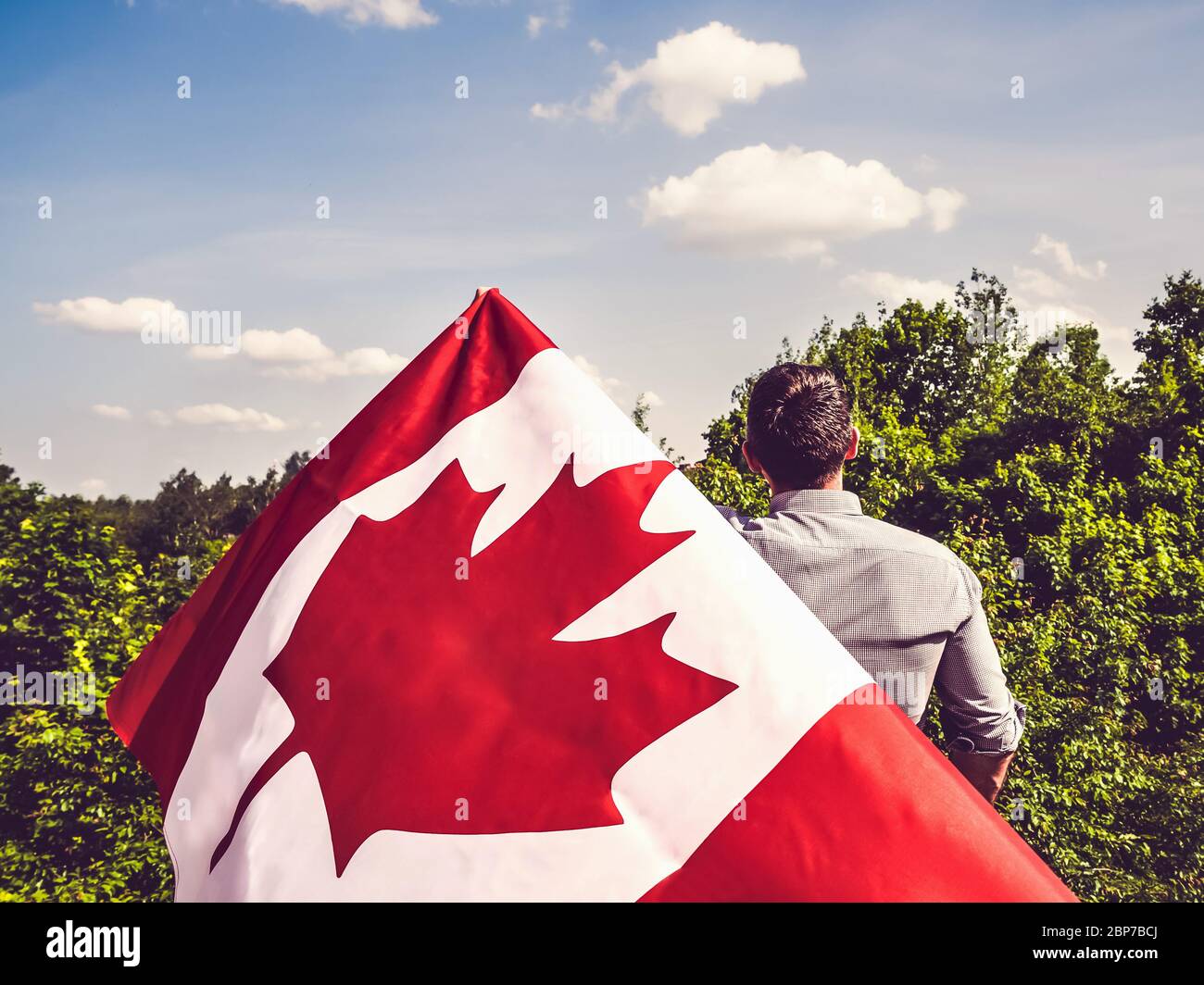 Attractive man holding Canadian Flag. National holiday Stock Photo - Alamy