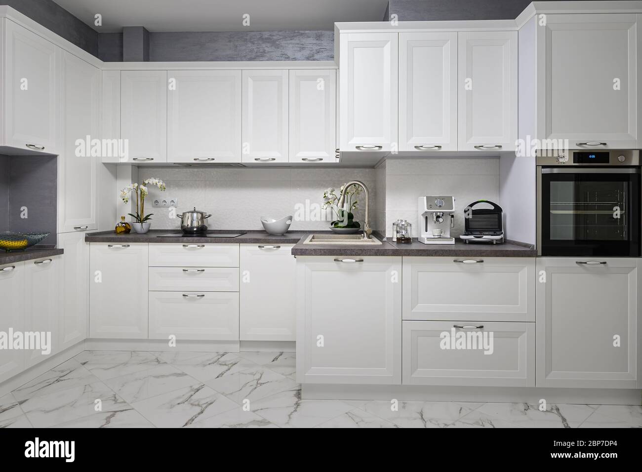 Clean and minimalistic modern white kitchen interior Stock Photo