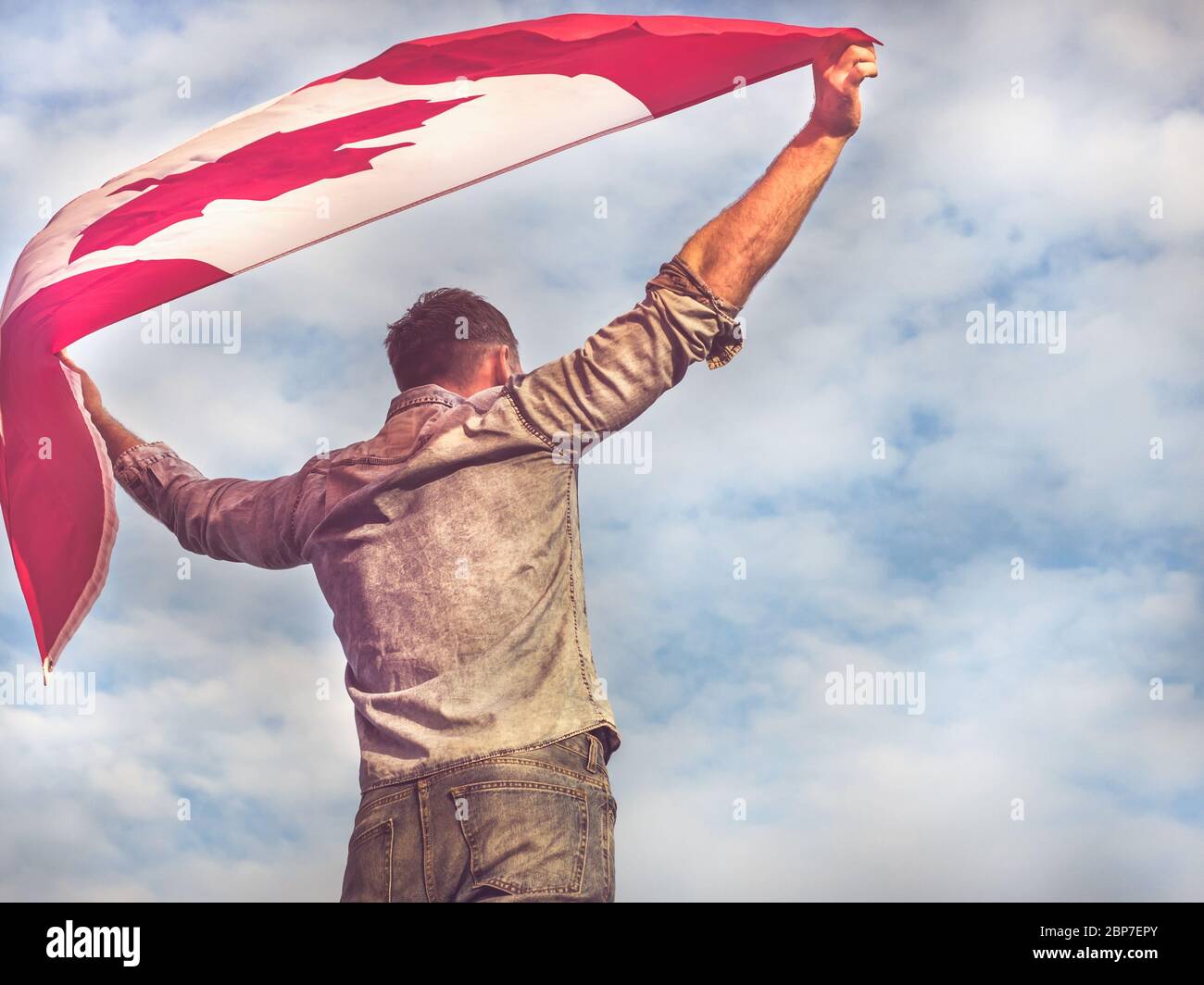 Attractive man holding Canadian Flag. National holiday Stock Photo - Alamy
