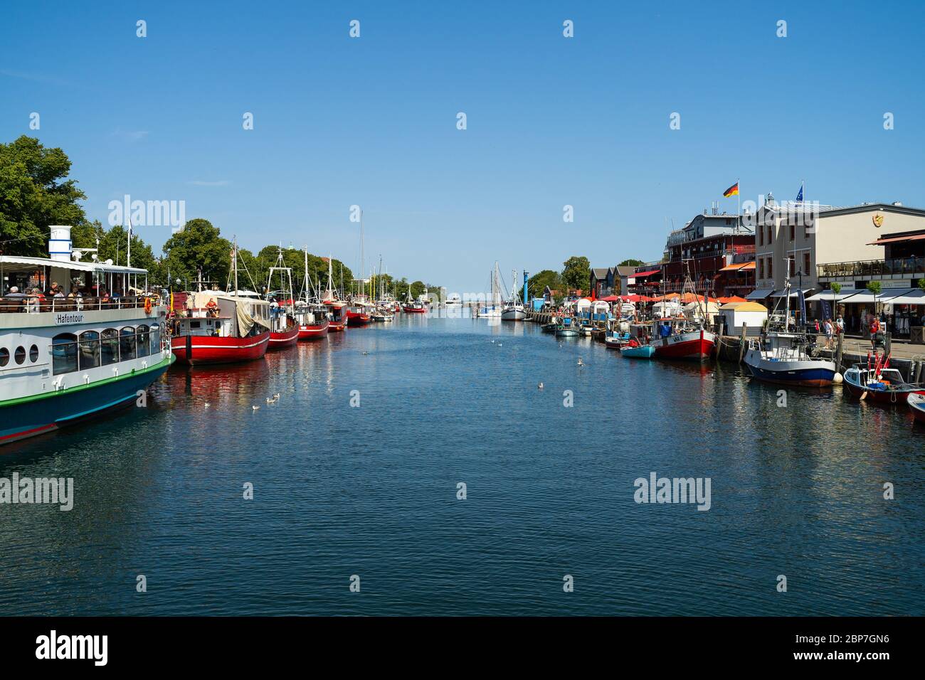 WARNEMUENDE (ROSTOCK), GERMANY - JULY 25, 2019: The view of the berths for ships and the historic quarter of Rostock - Warnemuende. Stock Photo