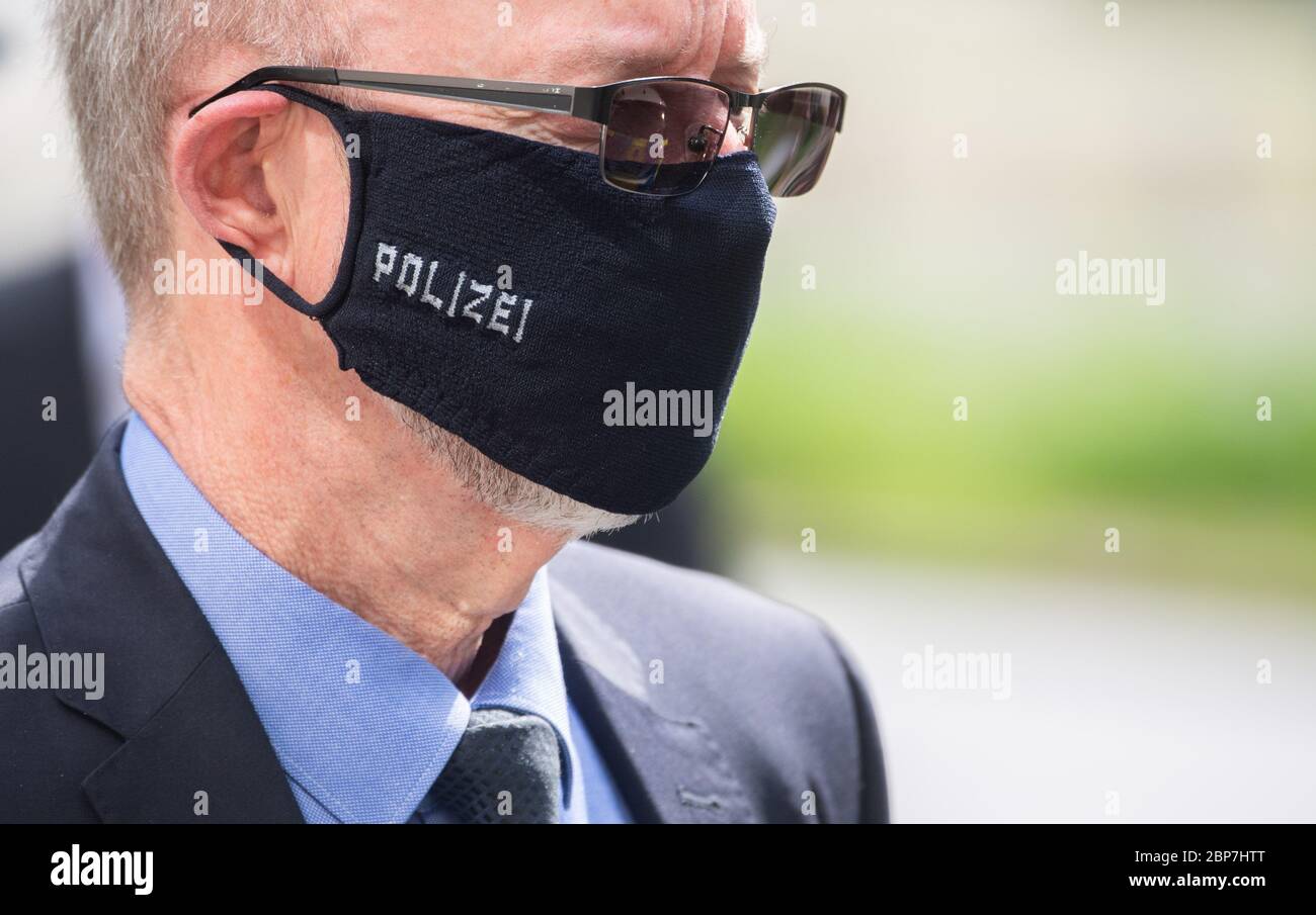 Hanover, Germany. 18th May, 2020. Volker Kluwe, police chief of Hanover, wears the prototype of a mouth and nose protector with the inscription 'Polizei' (police) at a press event. The police of Hanover has ordered larger quantities of these masks for its police officers. Credit: Julian Stratenschulte/dpa/Alamy Live News Stock Photo