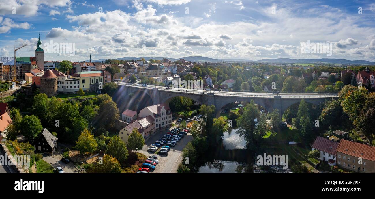 BAUTZEN, GERMANY - OCTOBER 10, 2019: Panoramic view of the town (apartment building, bridge and Spree river) from the height of the old Waterworks tower. Lens flare. Stock Photo
