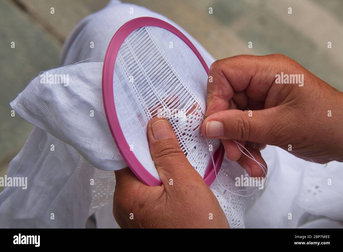 Close up of a lady's hands as she works on traditional fine detailed  needle craft in Norway, Scandinavia Stock Photo