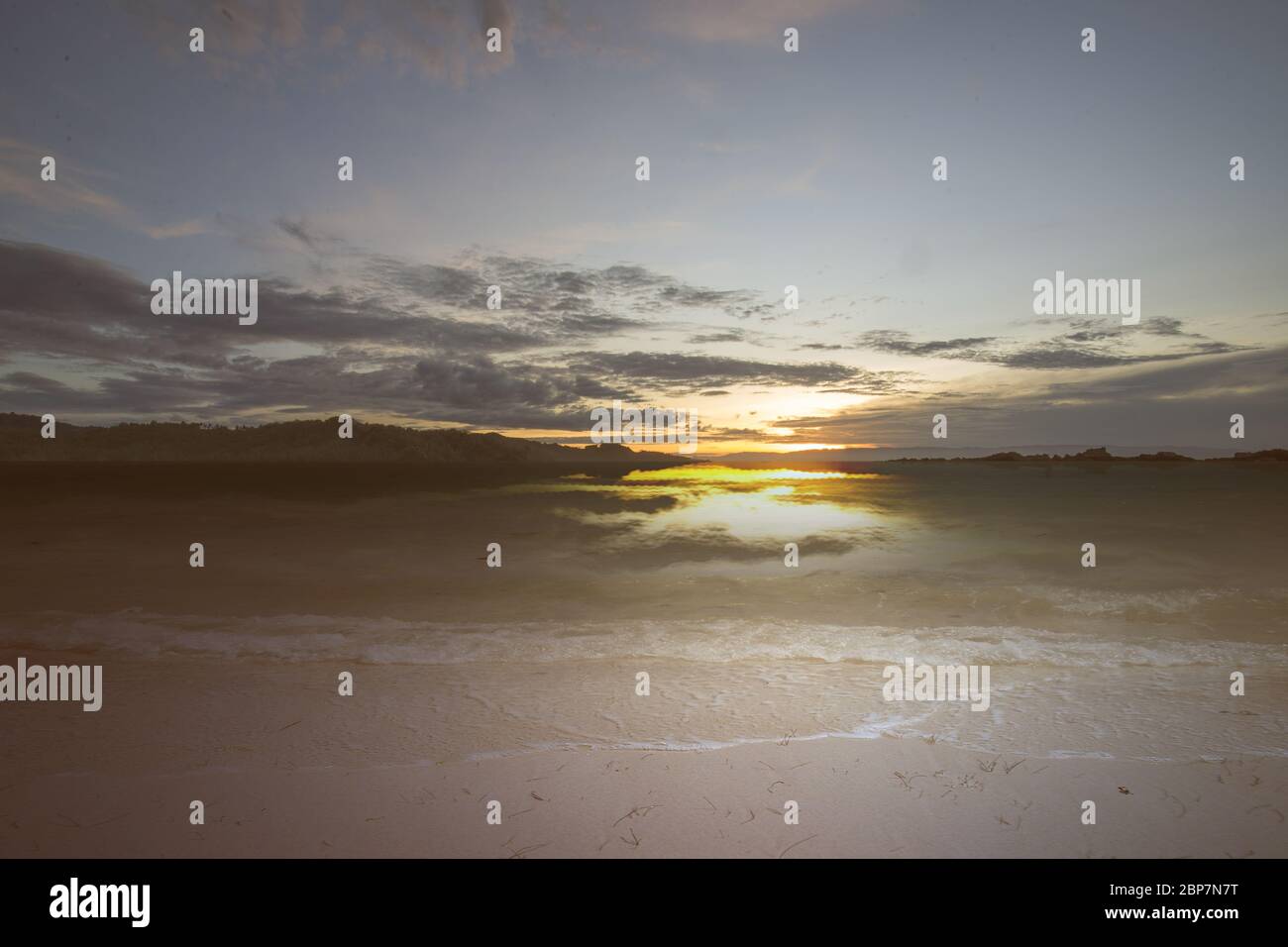 Sandy beach with the blue ocean and sunset sky background Stock Photo ...