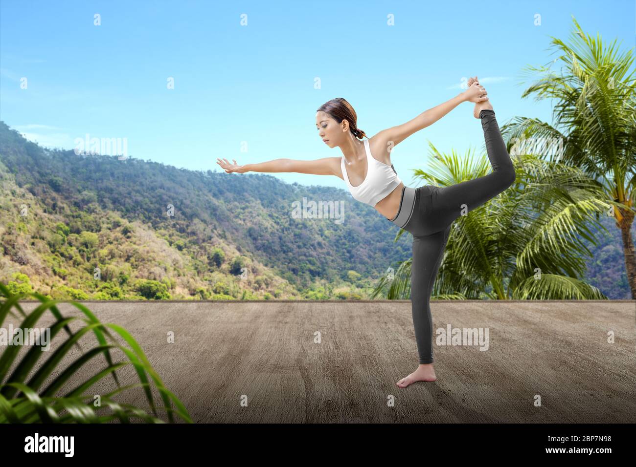 Asian woman is practicing yoga with mountain background Stock Photo - Alamy
