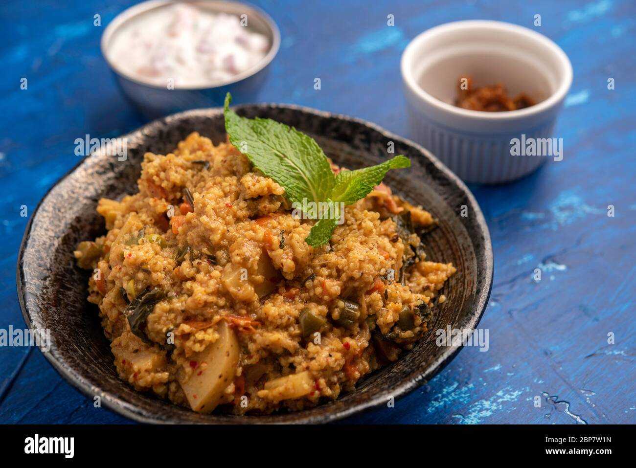Indian Millets Biryani with Raita and Pickle Stock Photo