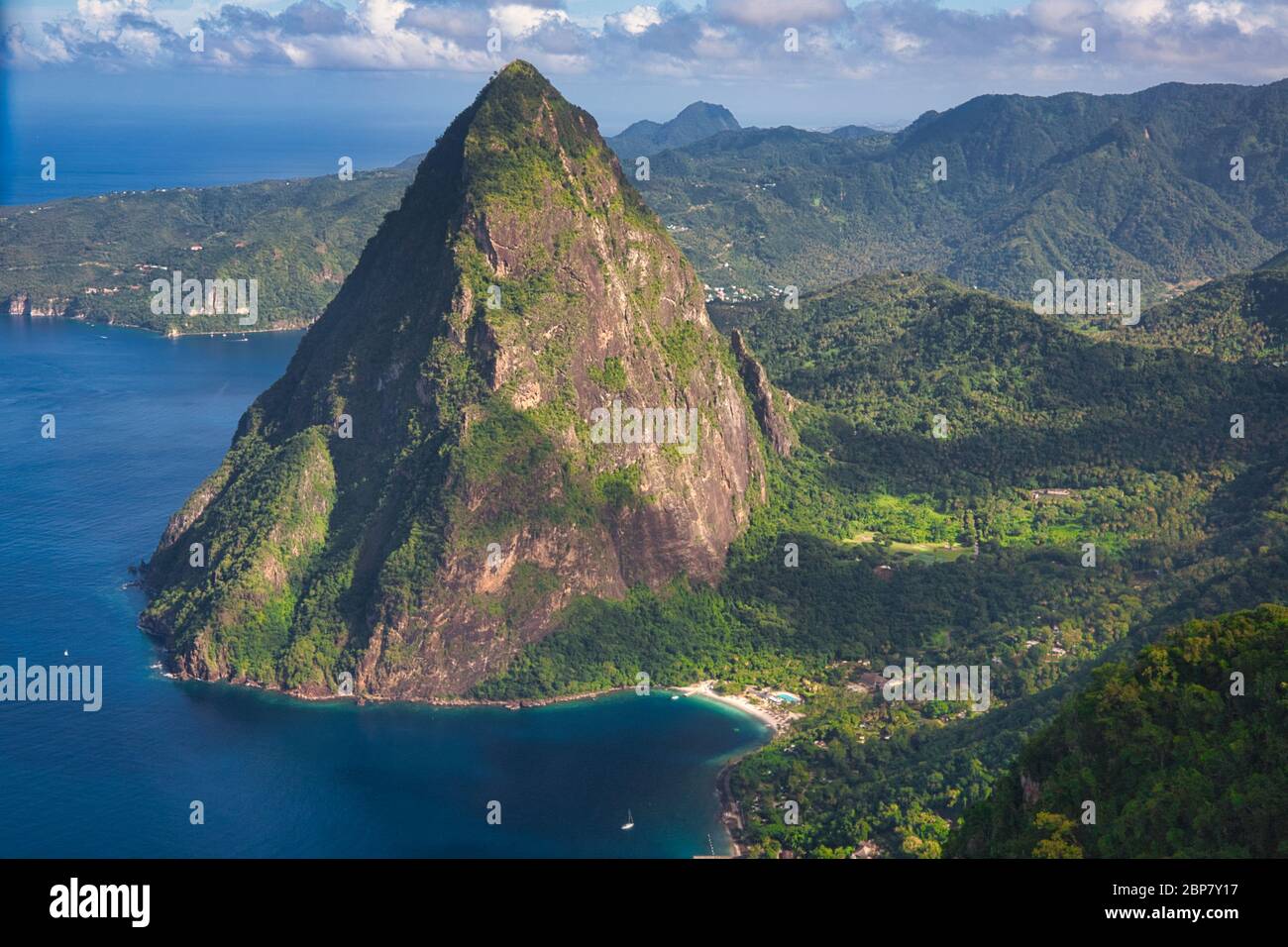 The peak of Gros Piton, tallest of two well known mountains in St Lucia, The Caribbean, West Indies. Aerial view with other green hills beyond Stock Photo