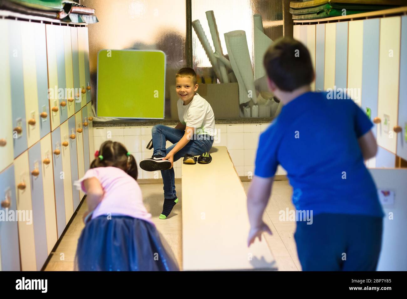 Children change their clothes in the wardrobe of a primary school ...