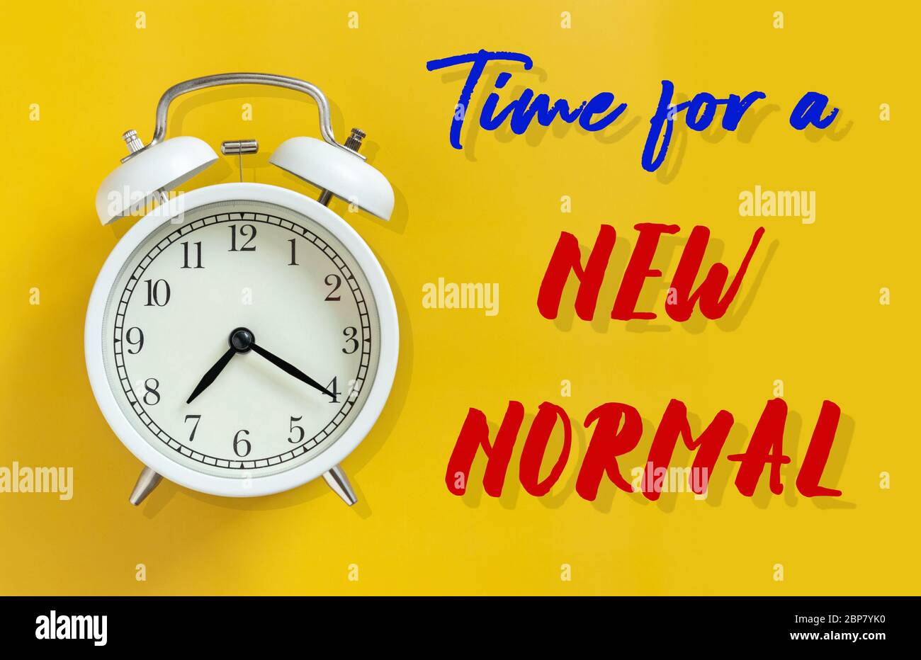 the new normal after COVID-19 Coronavirus pandemic concept. white alarm clock isolated on yellow background with text time for a new normal. a previou Stock Photo