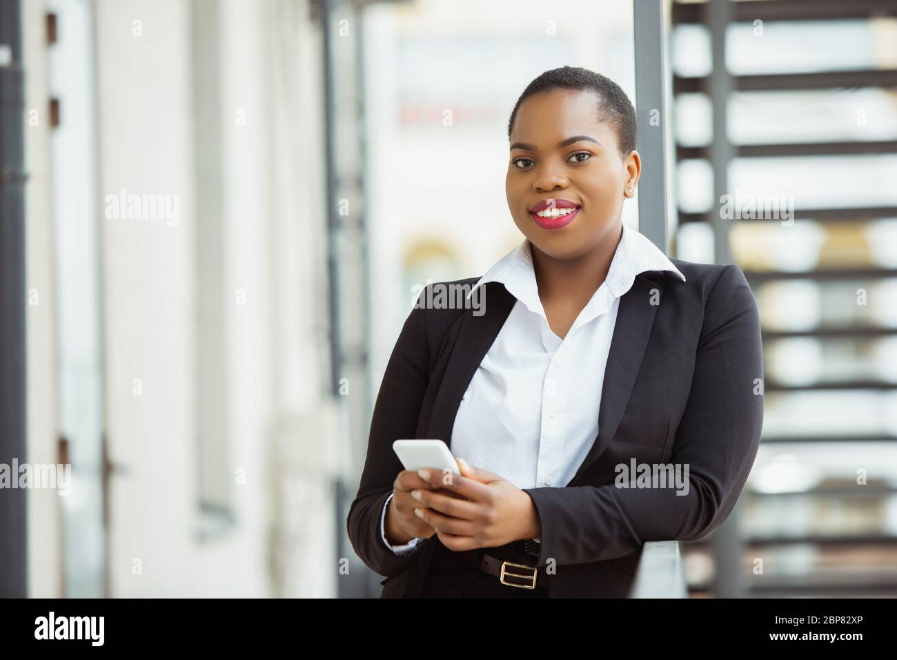 Confidence. African-american Businesswoman In Office Attire Smiling 