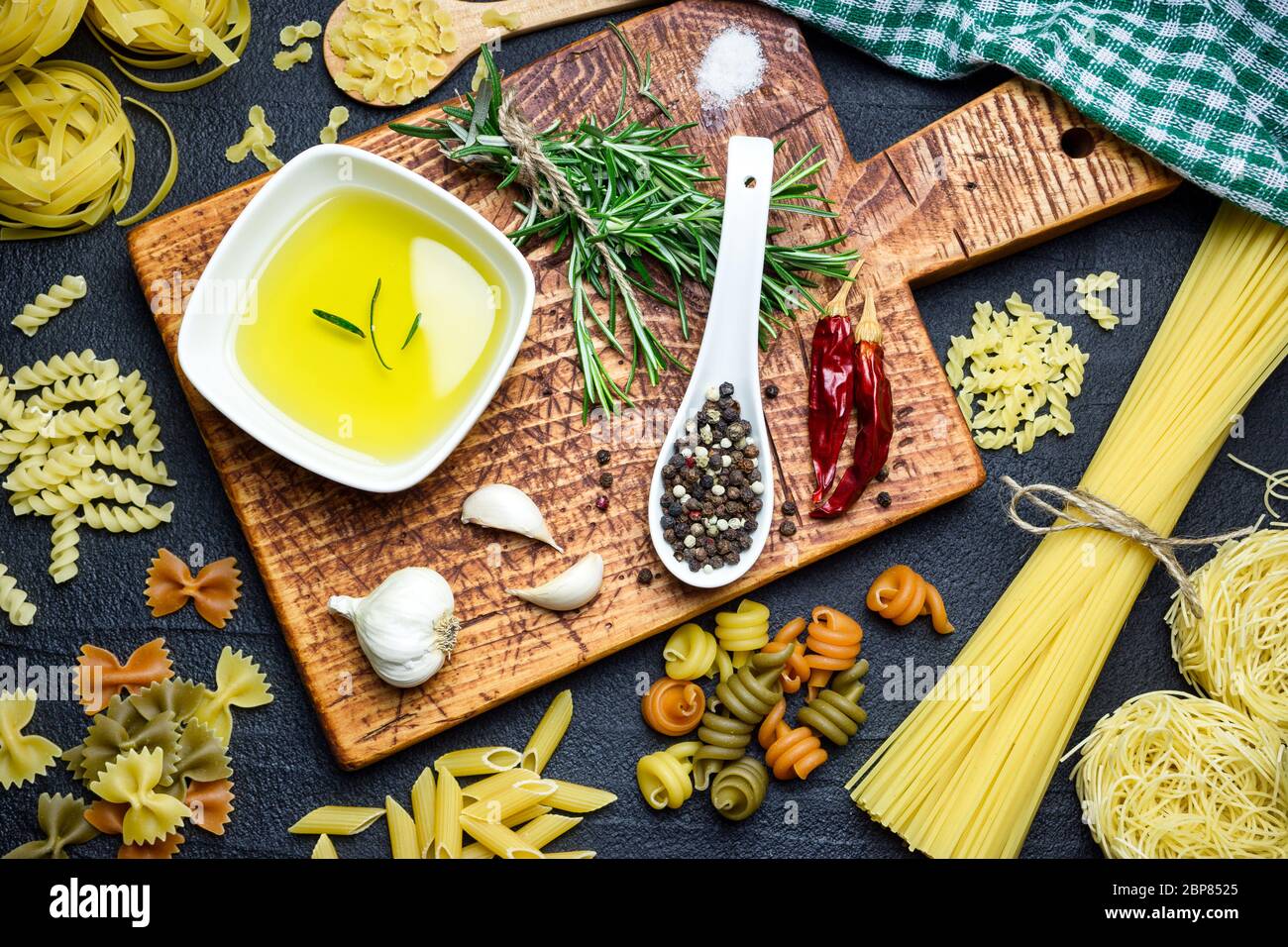 Ingredients for Italian cooking, pasta, herb, spices and olive oil on