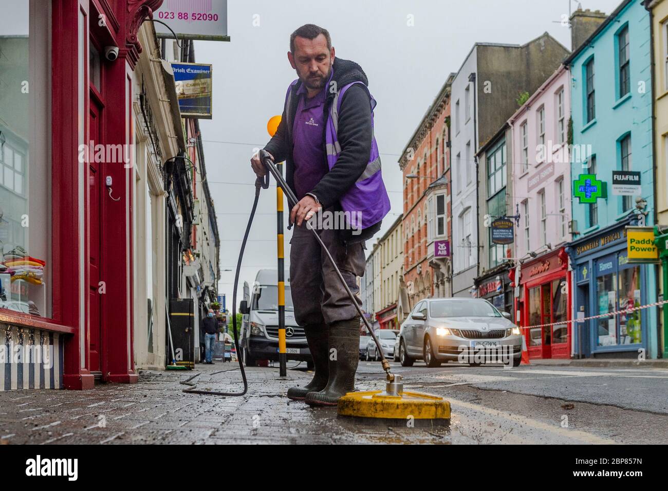 Bandon, West Cork, Ireland. 18th May, 2020. Bandon had its main street deep cleaned this morning, as part of the 'return to business' phase of exiting the Covid-19 lockdown, Soft Clean Group was tasked with performing the task in Bandon. Marcin Urbaniak, an employee, soft cleans the street. Credit: AG News/Alamy Live News Stock Photo
