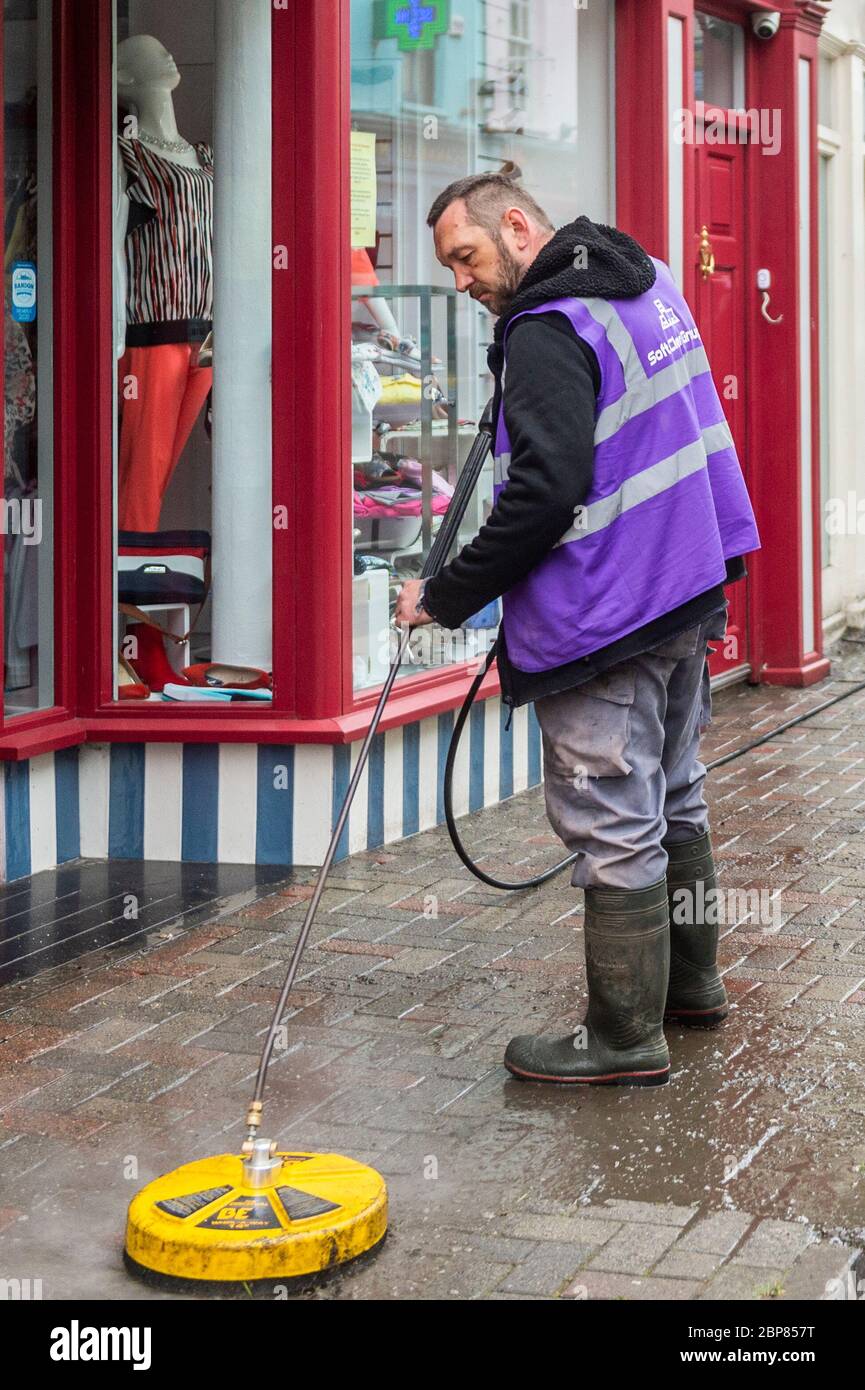 Bandon, West Cork, Ireland. 18th May, 2020. Bandon had its main street deep cleaned this morning, as part of the 'return to business' phase of exiting the Covid-19 lockdown, Soft Clean Group was tasked with performing the task in Bandon. Marcin Urbaniak, an employee, soft cleans the street. Credit: AG News/Alamy Live News Stock Photo