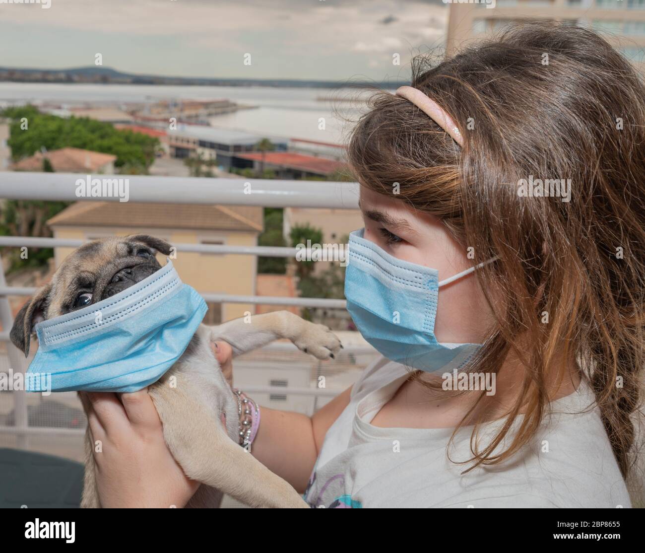 Kid and her pet wearing their masks Stock Photo Alamy
