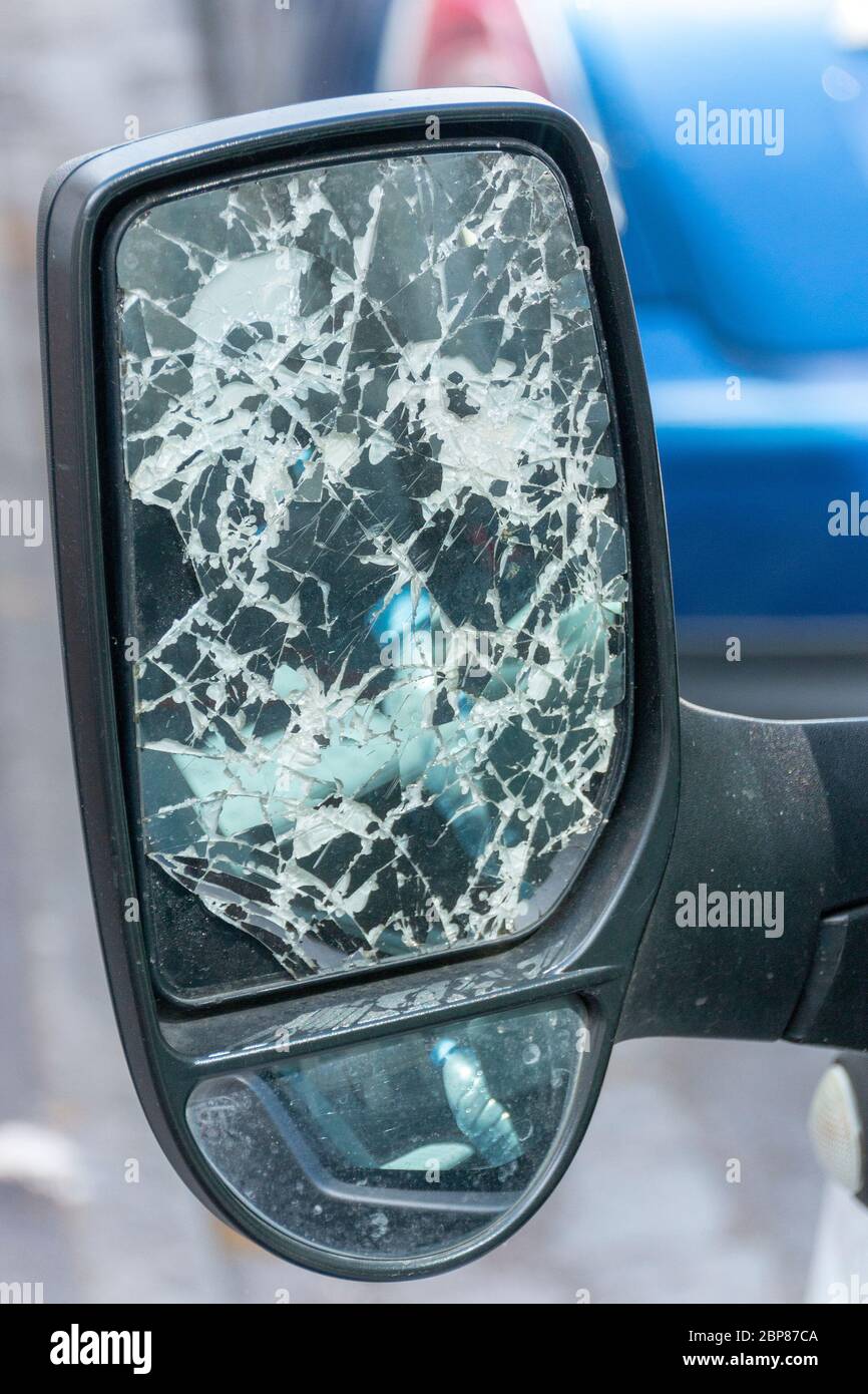 a close up view of a trucks side mirror that has been smashed Stock Photo