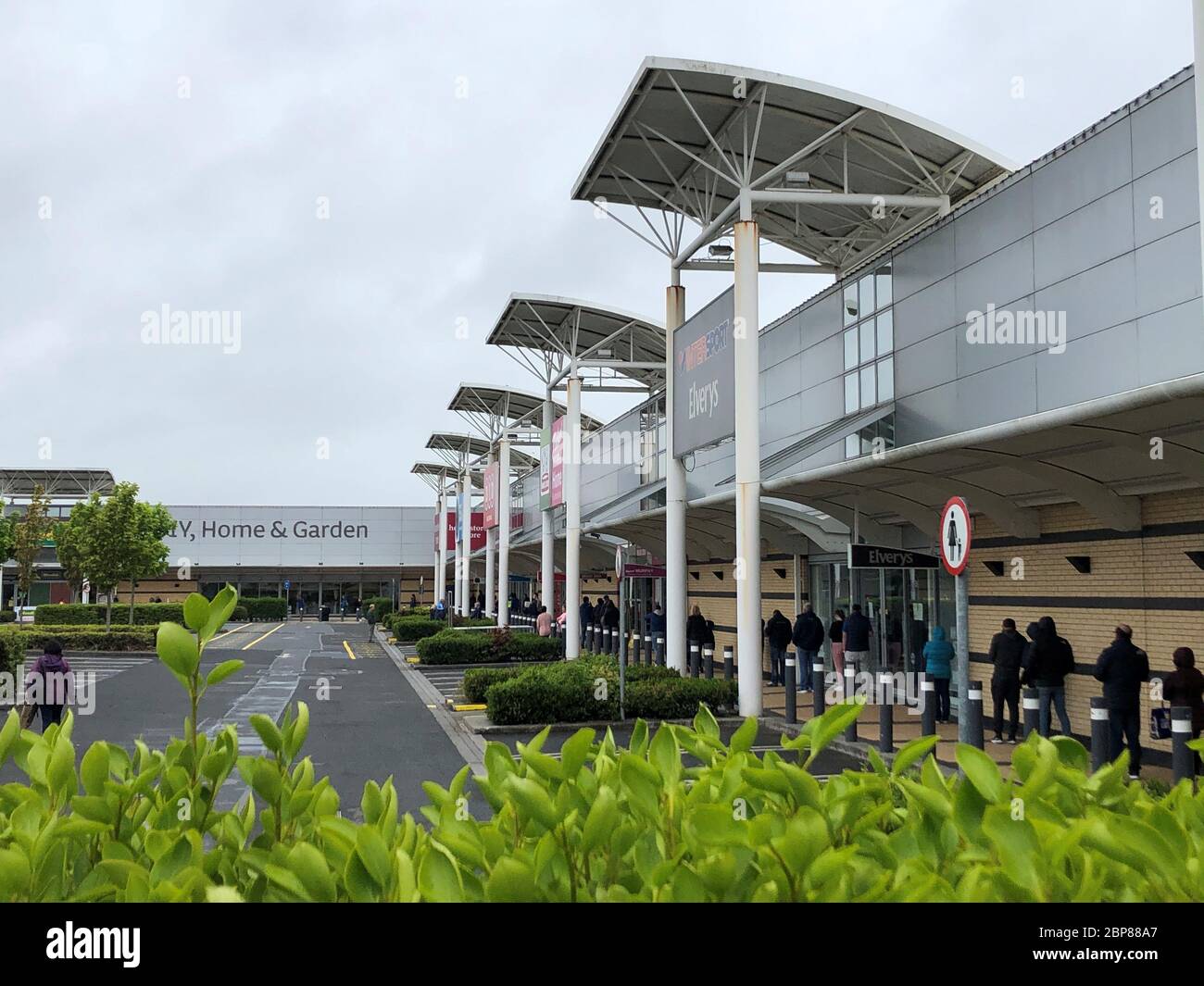 Shoppers queue to enter a hardware store at a retail park in Blanchardstown, Dublin, as phase one of Ireland's five phase exit plan was triggered on Monday. Stock Photo