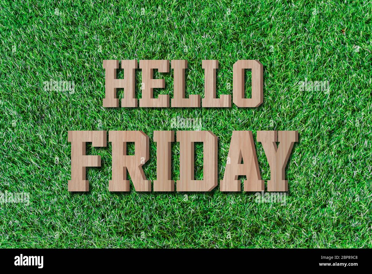 Hello friday made from wooden alphabet on green grass. Stock Photo