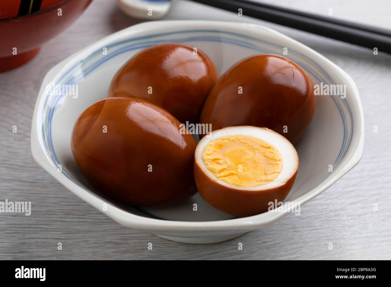 Bowl with whole and half traditional Asian soy sauce eggs, Shoyu tamago Stock Photo
