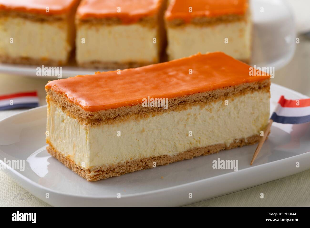 Traditional Dutch orange Tompouce pastry for kings day with Dutch flag