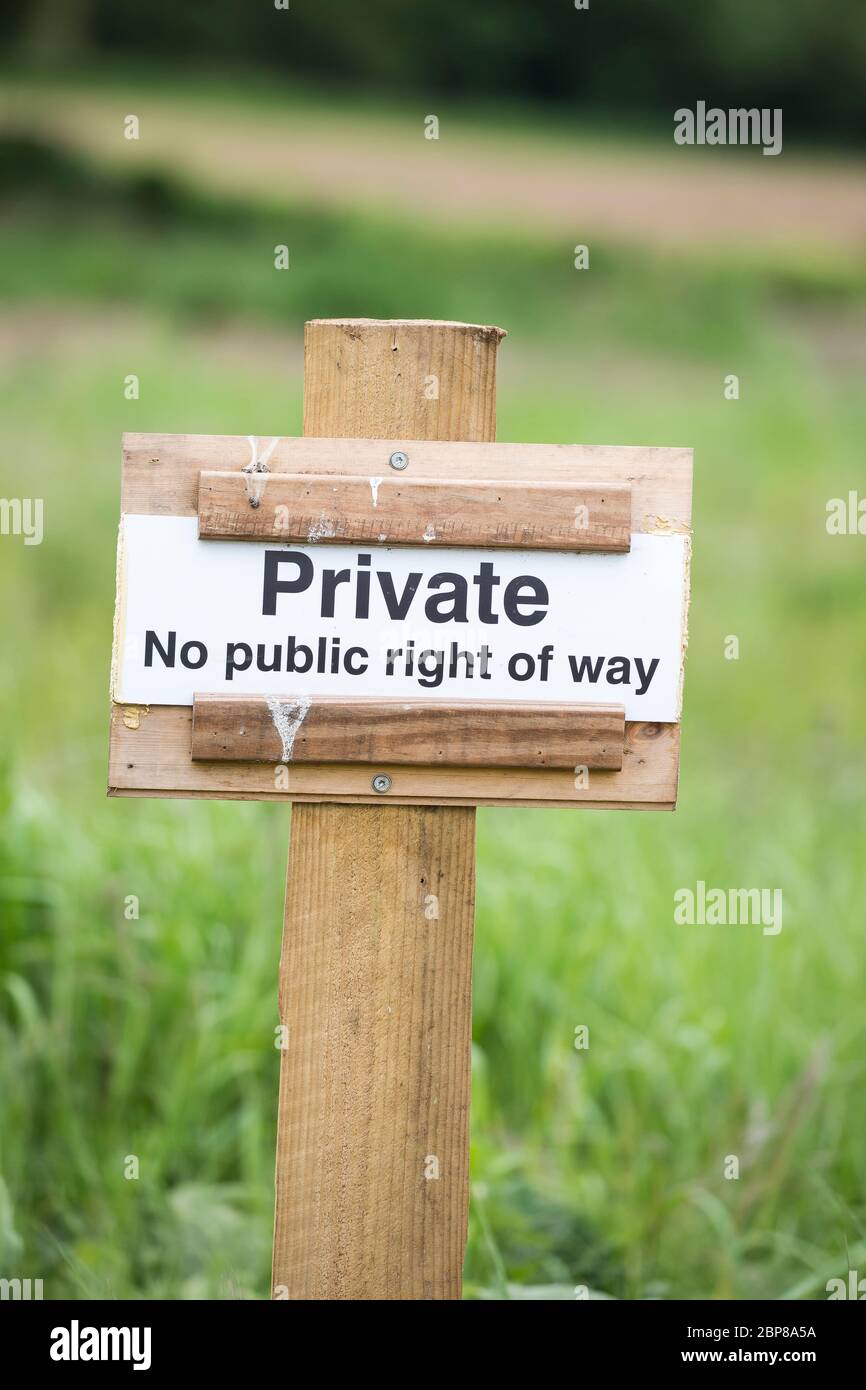 Close up of isolated countryside sign to ramblers & dog walkers: PRIVATE, No public right of way. Stock Photo