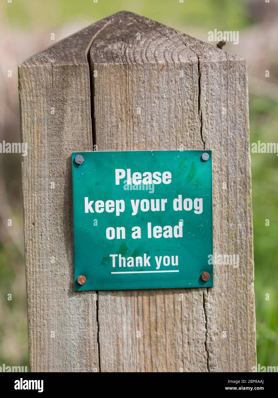 Sign on post to dog owners, notice to keep their dog on a lead when