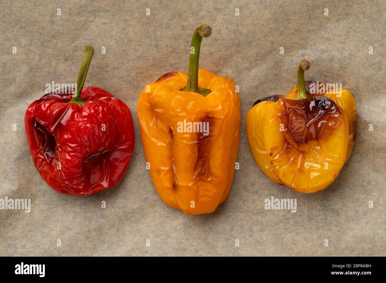 Grilled colorful bell peppers from the oven at baking paper Stock Photo
