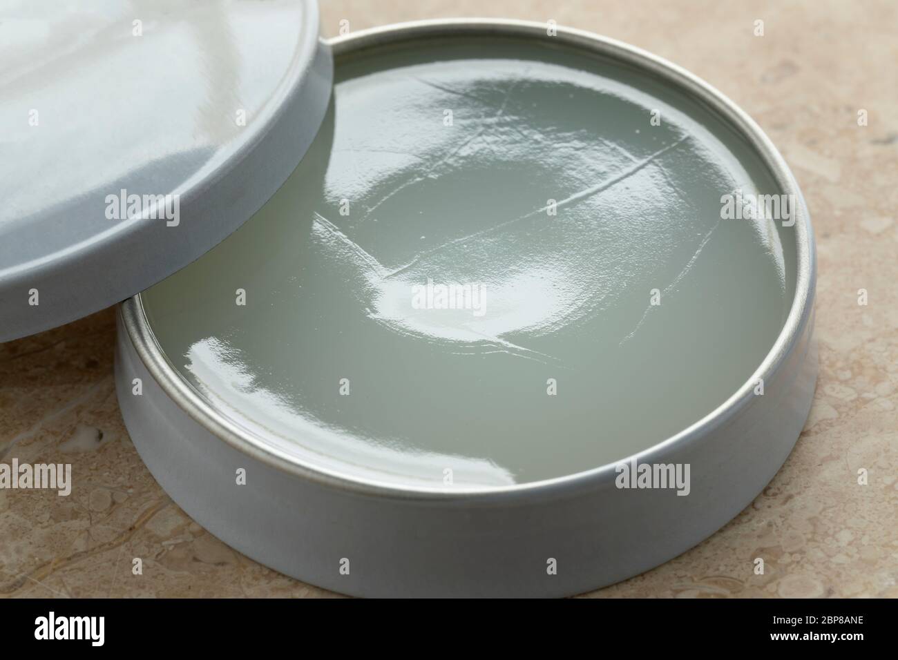 Little open tin and lid with vaseline Stock Photo