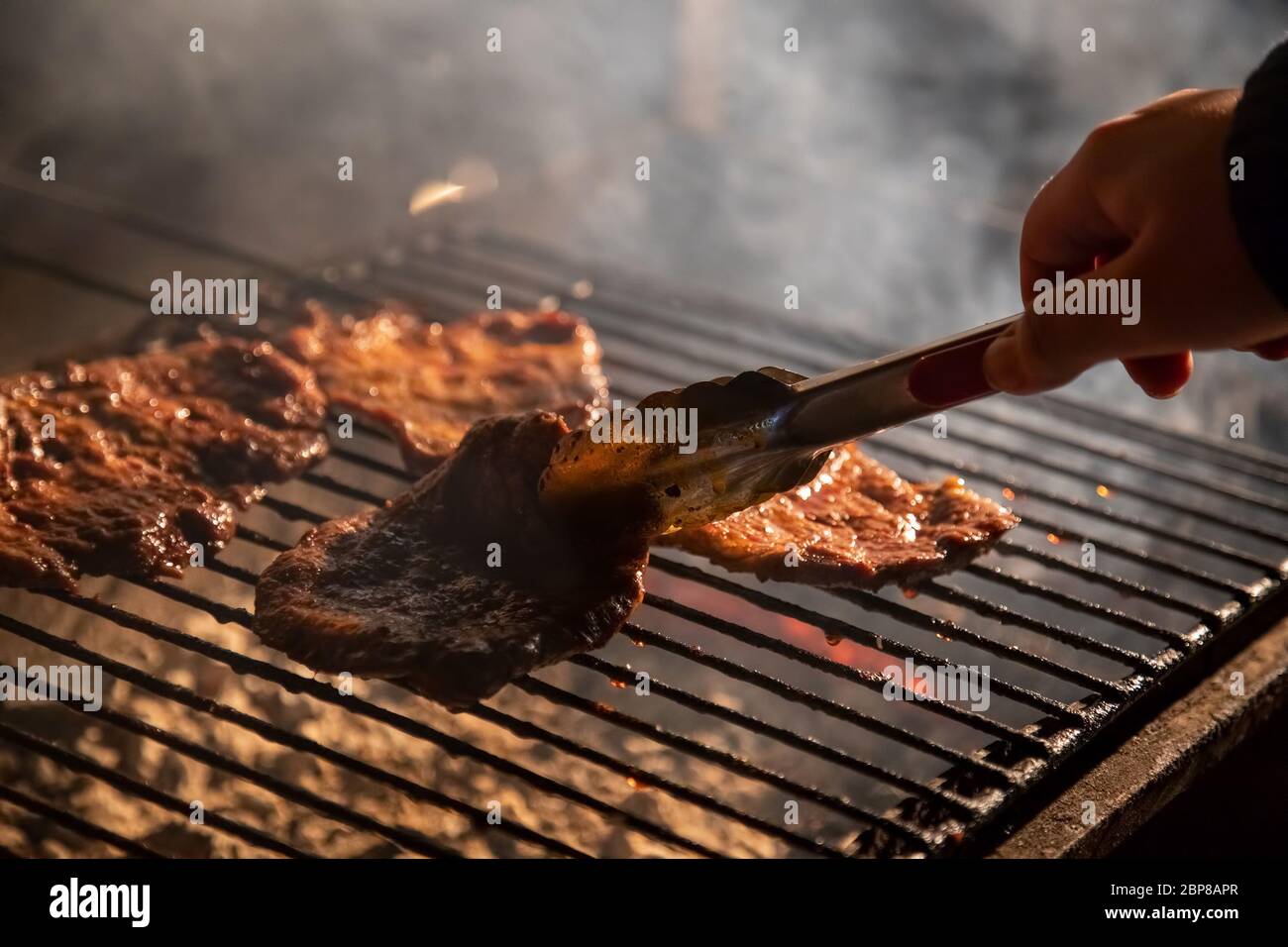 in the evening a barbecue grill on which tasty juicy steaks are grilled