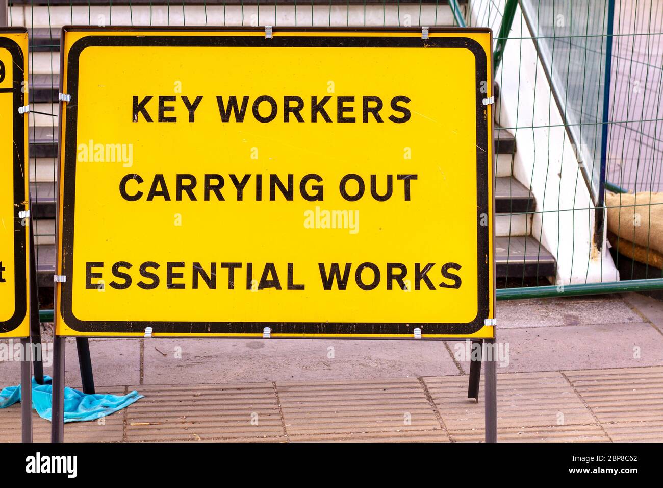 London, U.K. - 14 May 2020: A roadsign alerts people to key workers carrying out essential works Stock Photo