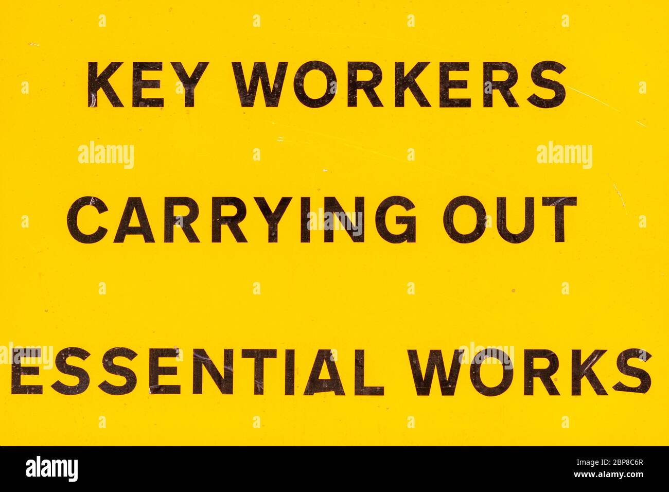 London, U.K. - 14 May 2020: A roadsign alerts people to key workers carrying out essential works Stock Photo