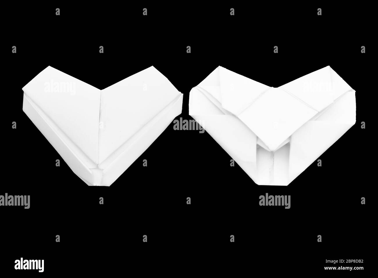 White paper origami heart isolated on black background. Front and back view Stock Photo