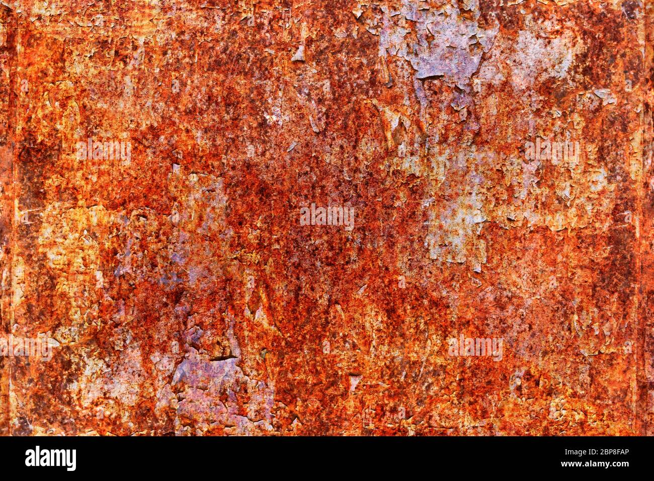 Grunge metal coroded texture. Old rusty metal plate heavily aged corrosion stain creates a grungy frame. Stock Photo