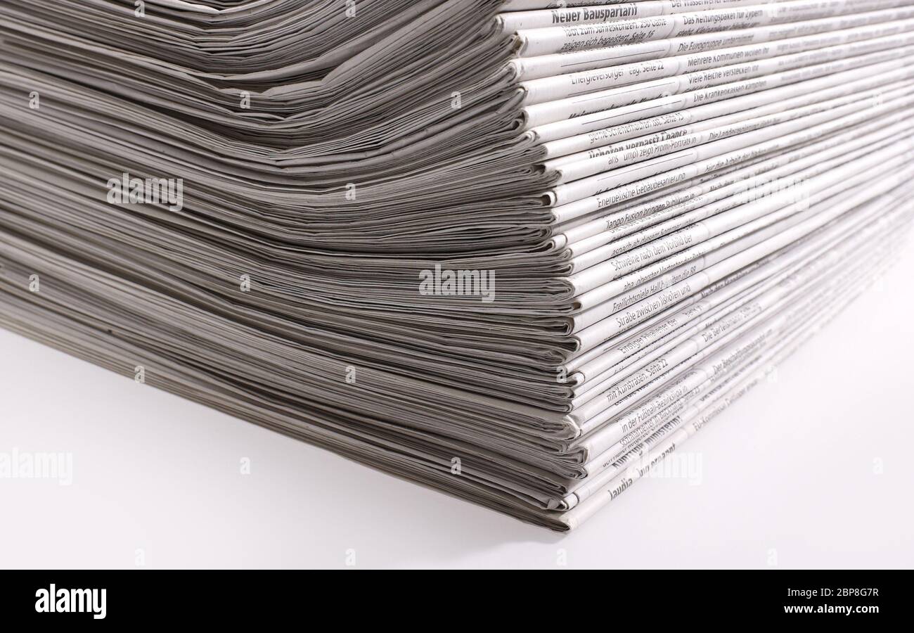 lots of stacked newspapers in light back Stock Photo