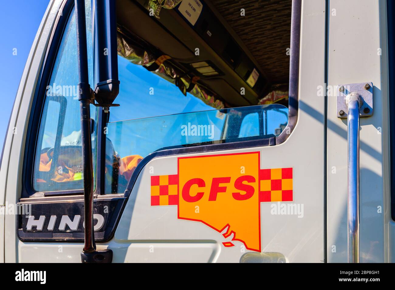 Adelaide Hills, South Australia - February 9, 2020: South Australian Country Fire Service truck door fragment with CFS logo in the centre on a bright Stock Photo