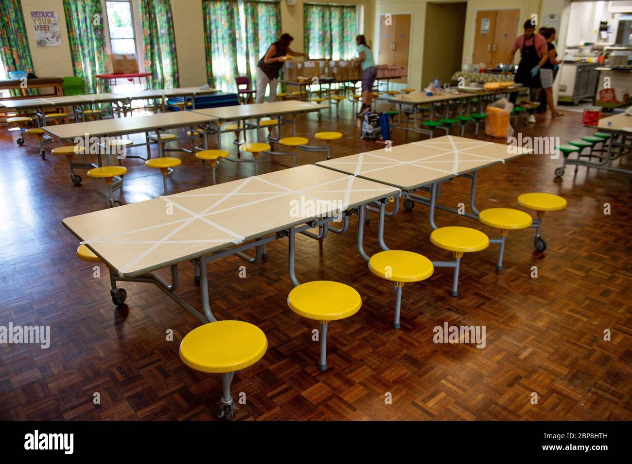 Tables are marked showing where children can sit during dinner time at Kempsey Primary School in Worcester. Nursery and primary pupils could return to classes from June 1 following the announcement of plans for a phased reopening of schools. Stock Photo