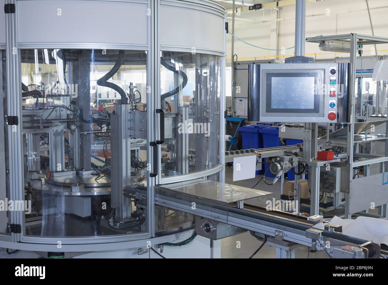 General view of the automatic production line with a control panel. All ...