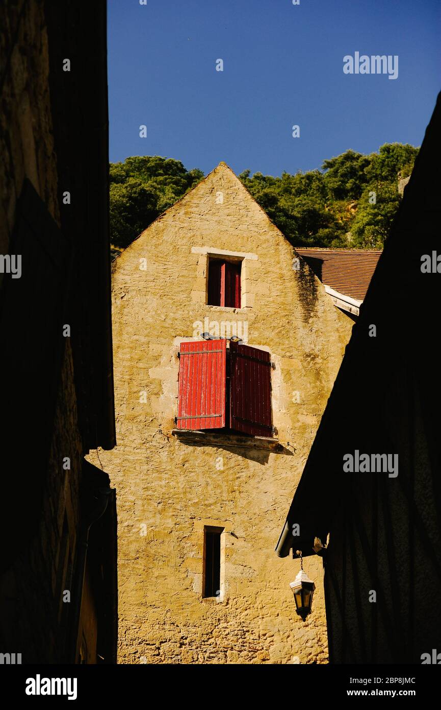 A red door high up on a building   One of the most beautiful villages in France La Roque-Gageac in the evening summer sun – Picture date Saturday 31 J Stock Photo