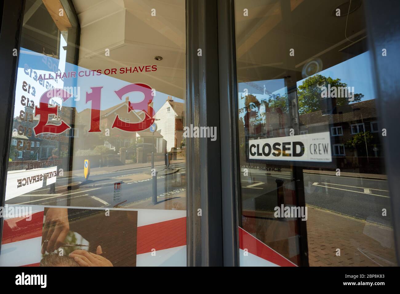 Photograph of closed sign in the window of a Barber's shop in Bexley. Taken during the week of the easing of the Coronavirus lockdown in the UK. Stock Photo