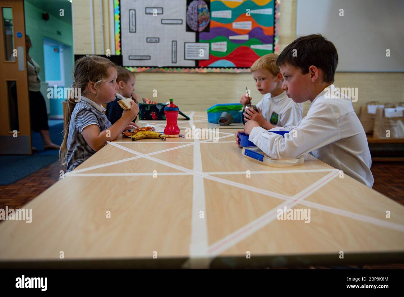 Children of essential workers eat lunch in segregated positions at Kempsey Primary School in Worcester. Nursery and primary pupils could return to classes from June 1 following the announcement of plans for a phased reopening of schools. Stock Photo
