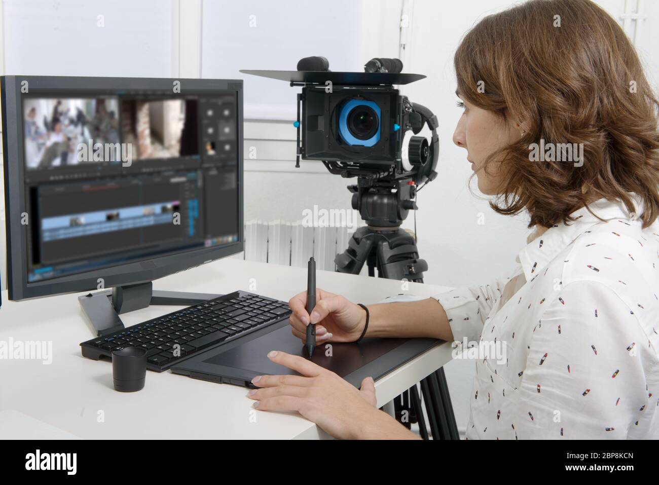 young female designer using graphics tablet for video editing Stock Photo