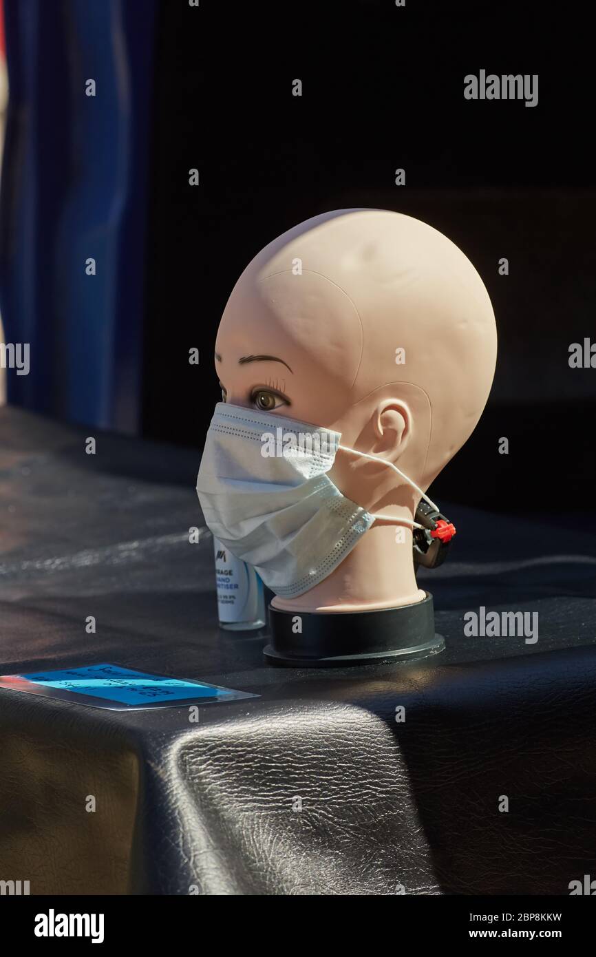 A mannequin head with face mask on a London market stall selling face