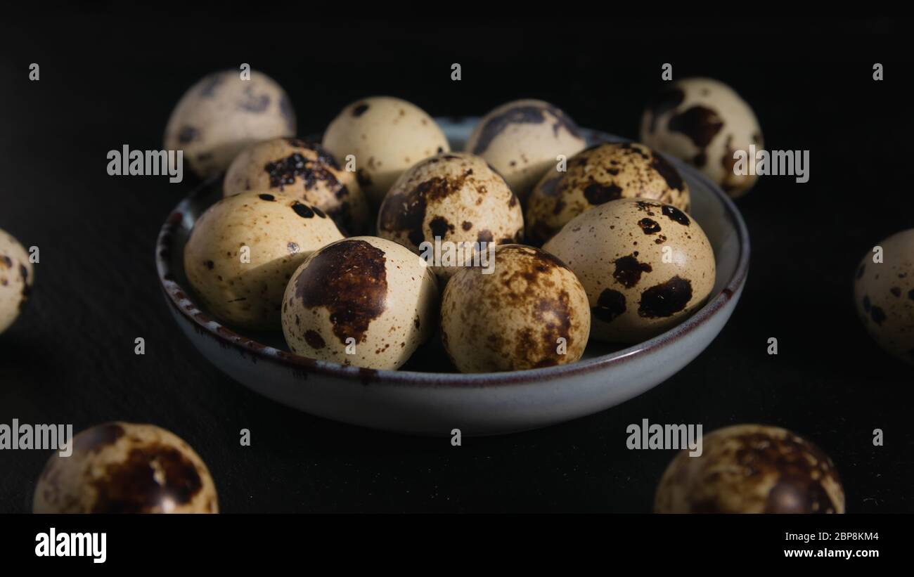 still life, quail eggs on a plate on a dark background, close-up Stock Photo