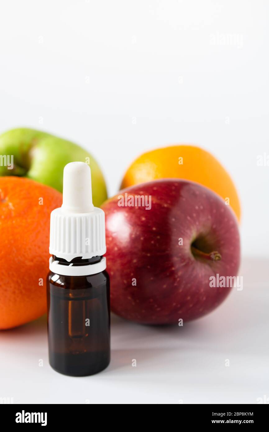 cosmetic concept, glass bottle with serum with alpha hydroxy acids on a background of fruit Stock Photo