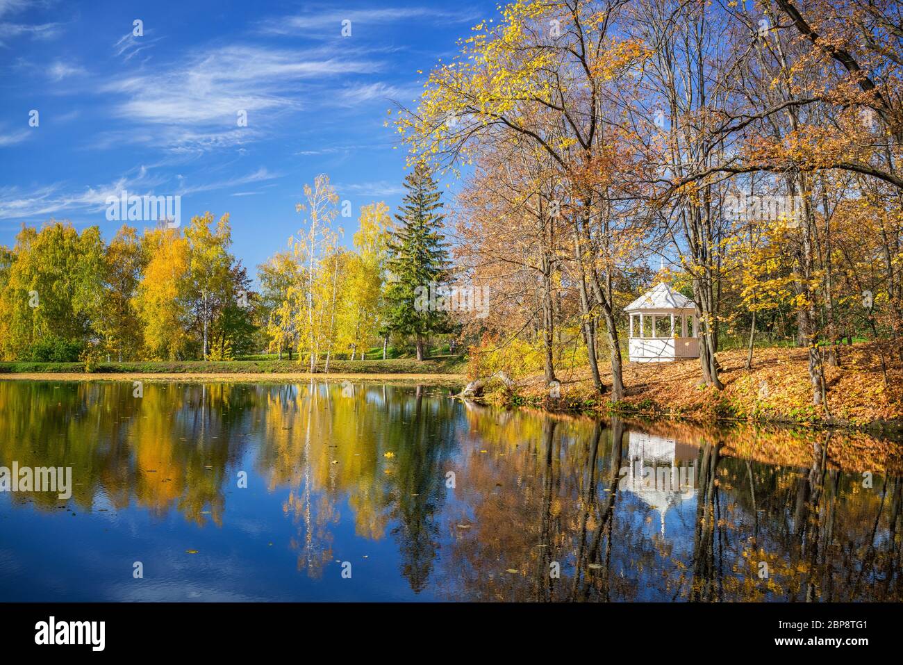 Sunny autumn landscape with blue sky over the lake Stock Photo